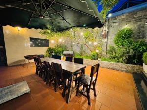 a wooden table and chairs on a patio at FREELANCE - Huy Ngân Villa in Da Lat