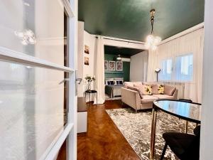 a living room with a couch and a table at CenterSide Condo in Bucharest