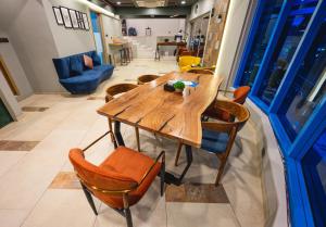 a dining room with a wooden table and chairs at Indie Stays Studios, Chembur in Mumbai