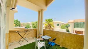 a balcony with chairs and a table on a balcony at Private Cottage in Sharjah
