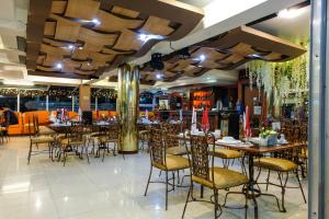 a restaurant with tables and chairs and a bar at PATIO RIZAL HOTEL Inc in Lucban