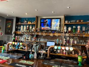a bar with a lot of bottles of alcohol at The Ship Hotel in Crediton