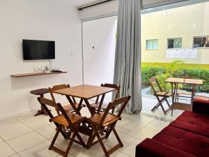a living room with a table and chairs and a couch at Maré in Morro de São Paulo