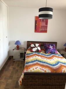 a bedroom with a bed with pillows on it at Appartement T3, avec terrasse, place de parking privée in Saintes-Maries-de-la-Mer