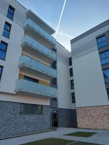 a rendering of a building with a large white billboard at JH Apartament in Kołobrzeg