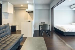 Ένα ή περισσότερα κρεβάτια σε δωμάτιο στο Vacation Rental Hotel TENMONKAN