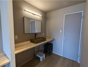 a bathroom with a sink and a mirror at Riverside Moire - spacious & sunny in Yoichi +22 photos