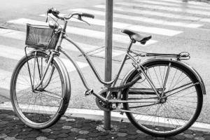 a bike chained to a pole next to a street at Riverside Moire - spacious & sunny in Yoichi