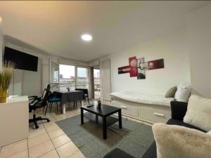 a living room with a couch and a table at T2 7 Lys - central, terrasse, garage in Saint-Louis