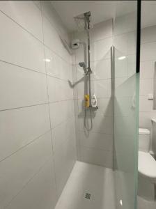 a shower with a glass door in a bathroom at T2 7 Lys - central, terrasse, garage in Saint-Louis +12 photos