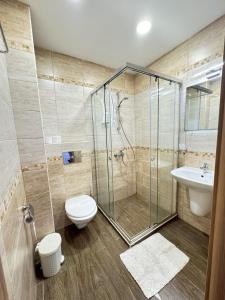 a bathroom with a shower and a toilet and a sink at Guest Apartment The Fabulous Sunset -Sozopol in Sozopol