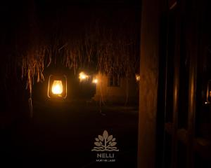 a night view of a house with a light in the dark at Nelli Mud Village in Thirunelli
