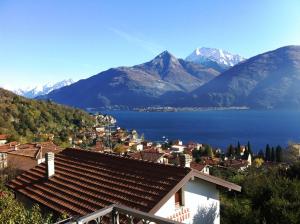 a view of a town with a lake and mountains at Casa Amarilla in San Siro