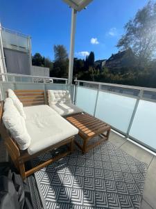 a balcony with two chairs and a bench on a roof at Deluxe Apartment Ruhr Oase, Neubau, 4 Personen, Parkplatz, in Bochum