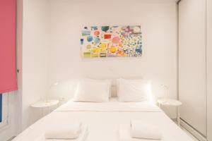 um quarto branco com uma cama branca e um quadro em Amazing Modern Central Apt in Athens em Atenas