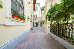 an alley between two buildings with potted plants at Emil Balaban Luxury Apart-Hotel in Bucharest +137 photos