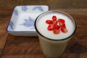 a drink with fruit on top of it on a table at Boutique Hotel Riad Almoulouk in Marrakesh