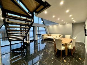 Una habitación con una mesa y sillas y una escalera. en 4 bedroom, 5 bathroom triangle, en Gabala