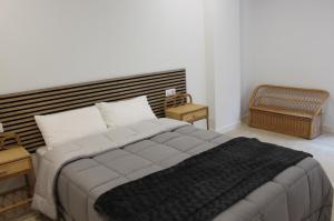 a bedroom with a large bed and two night stands at XELIÑA c in A Estrada