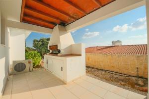 an outdoor kitchen with a view of a brick wall at Villa Helena in Peyia