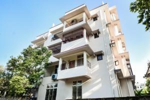 an image of a white building at Super Hotel O Royal Pearl Inn in Guwahati