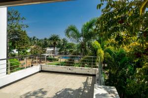 a balcony with a view of a pool at Nahar Farmland - Green Heaven in Tirupporūr