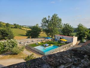 an aerial view of a house with a swimming pool at Domaine de Massoulac in Molières