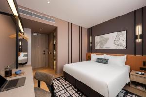 Postel nebo postele na pokoji v ubytování Citadines Connect Cecil Georgetown Penang