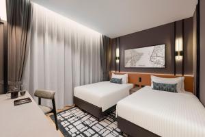 Postel nebo postele na pokoji v ubytování Citadines Connect Cecil Georgetown Penang