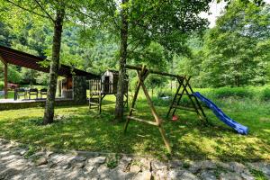 a playground with a slide and a swing set at Villa VEGA - Gorseti in Gornji Šajn