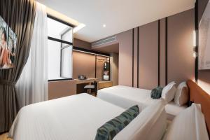 Postel nebo postele na pokoji v ubytování Citadines Connect Cecil Georgetown Penang
