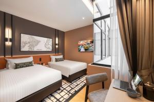 Postel nebo postele na pokoji v ubytování Citadines Connect Cecil Georgetown Penang