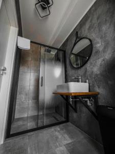 a bathroom with a sink and a shower with a mirror at Pensiunea 82 in Nădlac +21 photos