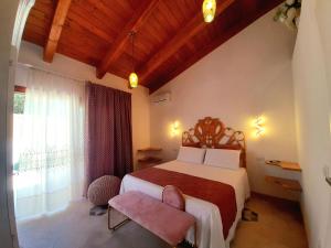 a bedroom with a large bed and a window at Girasole Boutique B&B in Riola Sardo