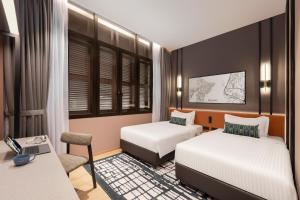 Postel nebo postele na pokoji v ubytování Citadines Connect Cecil Georgetown Penang
