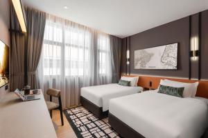 Postel nebo postele na pokoji v ubytování Citadines Connect Cecil Georgetown Penang
