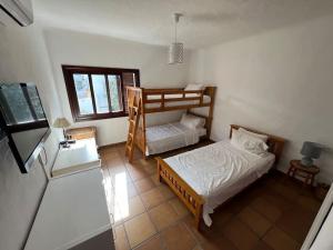 a bedroom with two bunk beds and a window at Kabila Marina 2 Beach Haven - Your Coastal Escape in M'diq