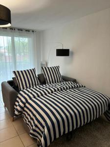 Ένα ή περισσότερα κρεβάτια σε δωμάτιο στο Super appartement familial Disneyland Paris 5pers