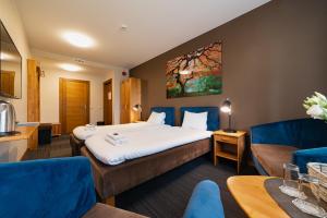 a hotel room with a bed and a couch at Comfort Hotel Kuldiga in Kuldīga