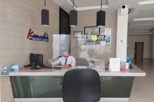 a man sitting at a desk with a computer at Kanasha Islami in Medan +24 photos