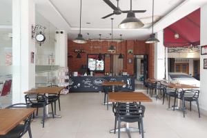 a restaurant with tables and chairs and a counter at Kanasha Islami in Medan