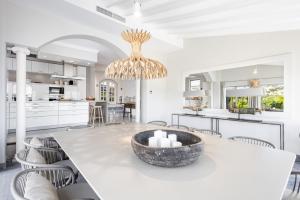 a kitchen and dining room with a large table and chairs at Villa Mimosa in Andratx