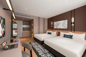 Postel nebo postele na pokoji v ubytování Citadines Connect Cecil Georgetown Penang