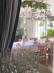a dining room with a table with glasses on it at Pension a restaurace Filip II in Mariánské Lázně