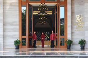 three men in red uniforms standing in a doorway at Al Meroz Hotel Bangkok - The Leading Halal Hotel in Bangkok