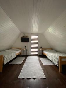 a room with two beds and a television and a window at Studio apartman Farah in Bihać