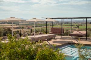 a patio with chairs and umbrellas and a pool at Son Sabater by Zafiro in Sa Pobla