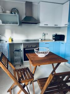 a kitchen with a wooden table and two chairs at Casa Capri in Torre-Guil +3 photos
