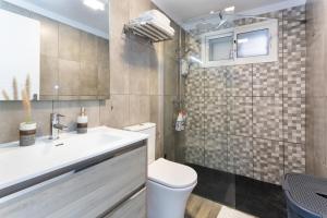 a bathroom with a toilet and a sink at Villa Candelaria in La Matanza de Acentejo +15 photos