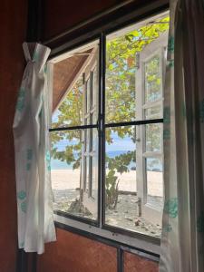 an open window with a view of a beach at Pansand Resort in Ko Bulon Le +30 photos